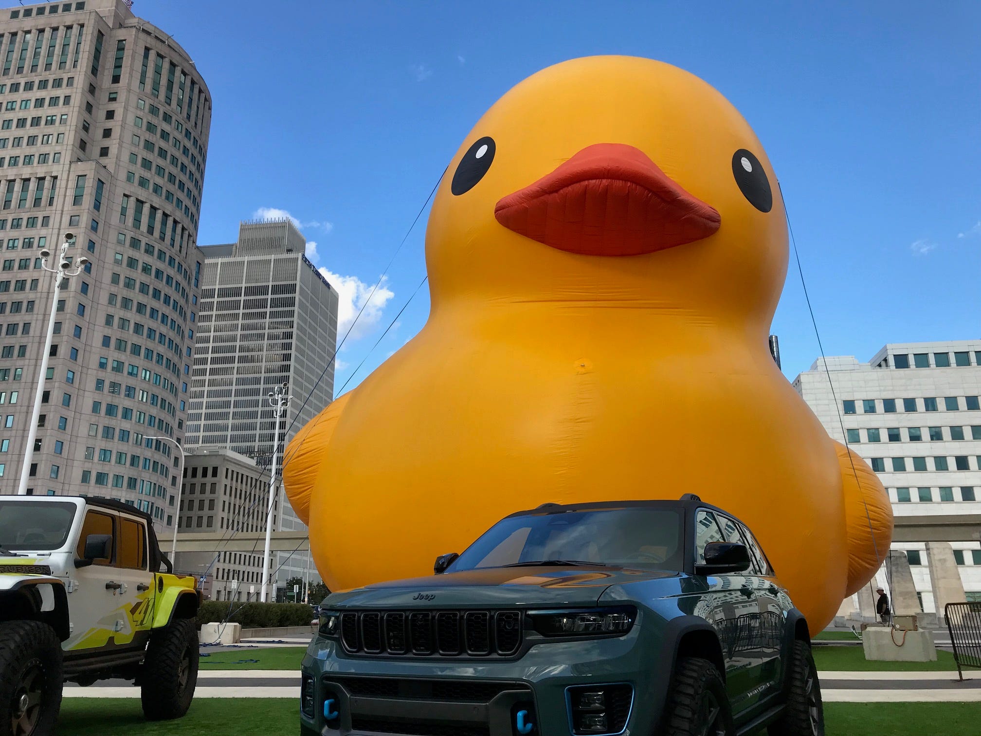 A huge rubber duck is inflated next to two Jeeps in front of Huntington Place in preparation for the North American International Auto Show in Detroit on Sept. 13, 2022.