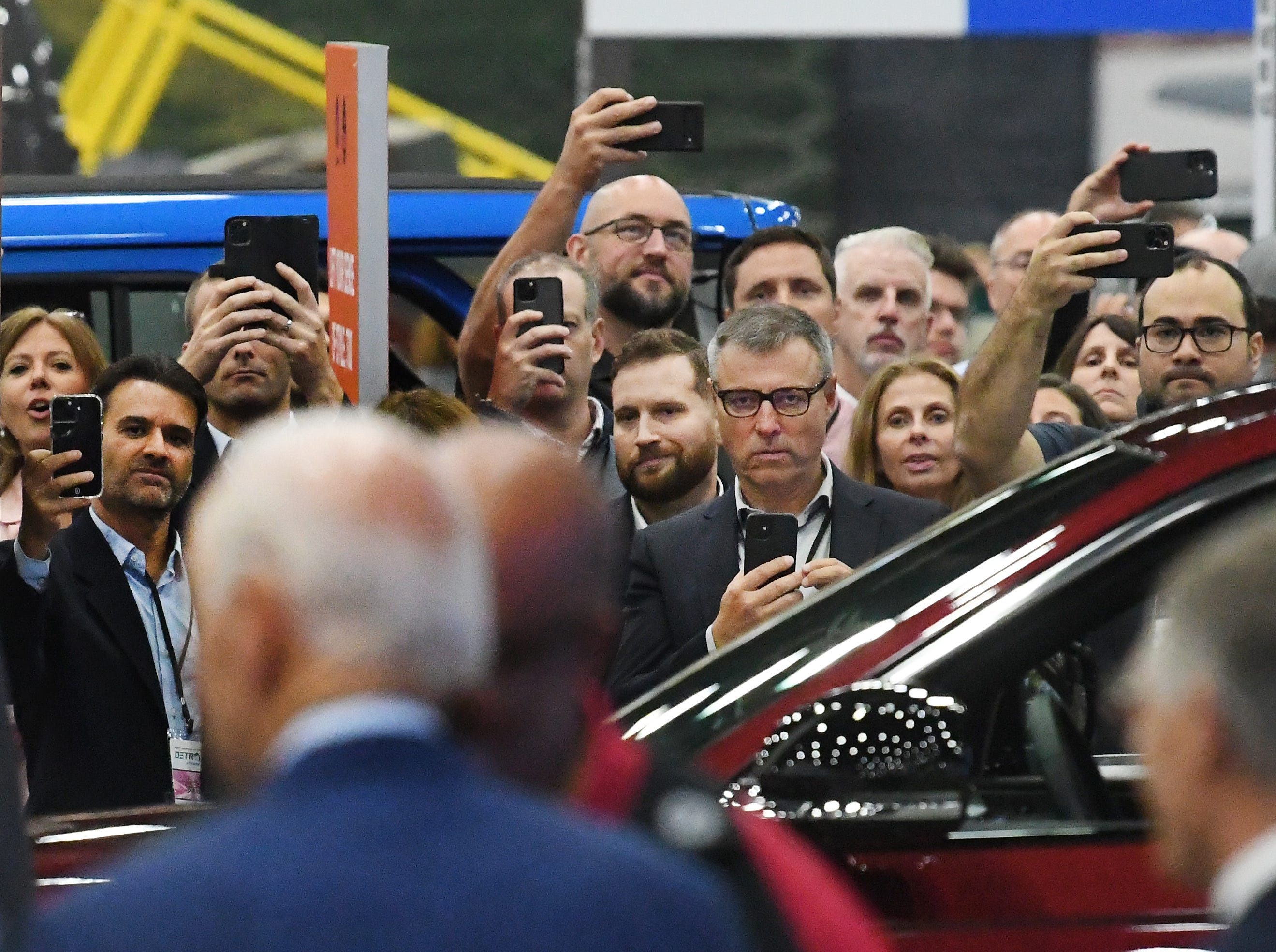 Visitors to the North American International Auto Show Media Day get some shots of President Joe Biden during a tour of the show in Detroit, Michigan on September 14, 2022.