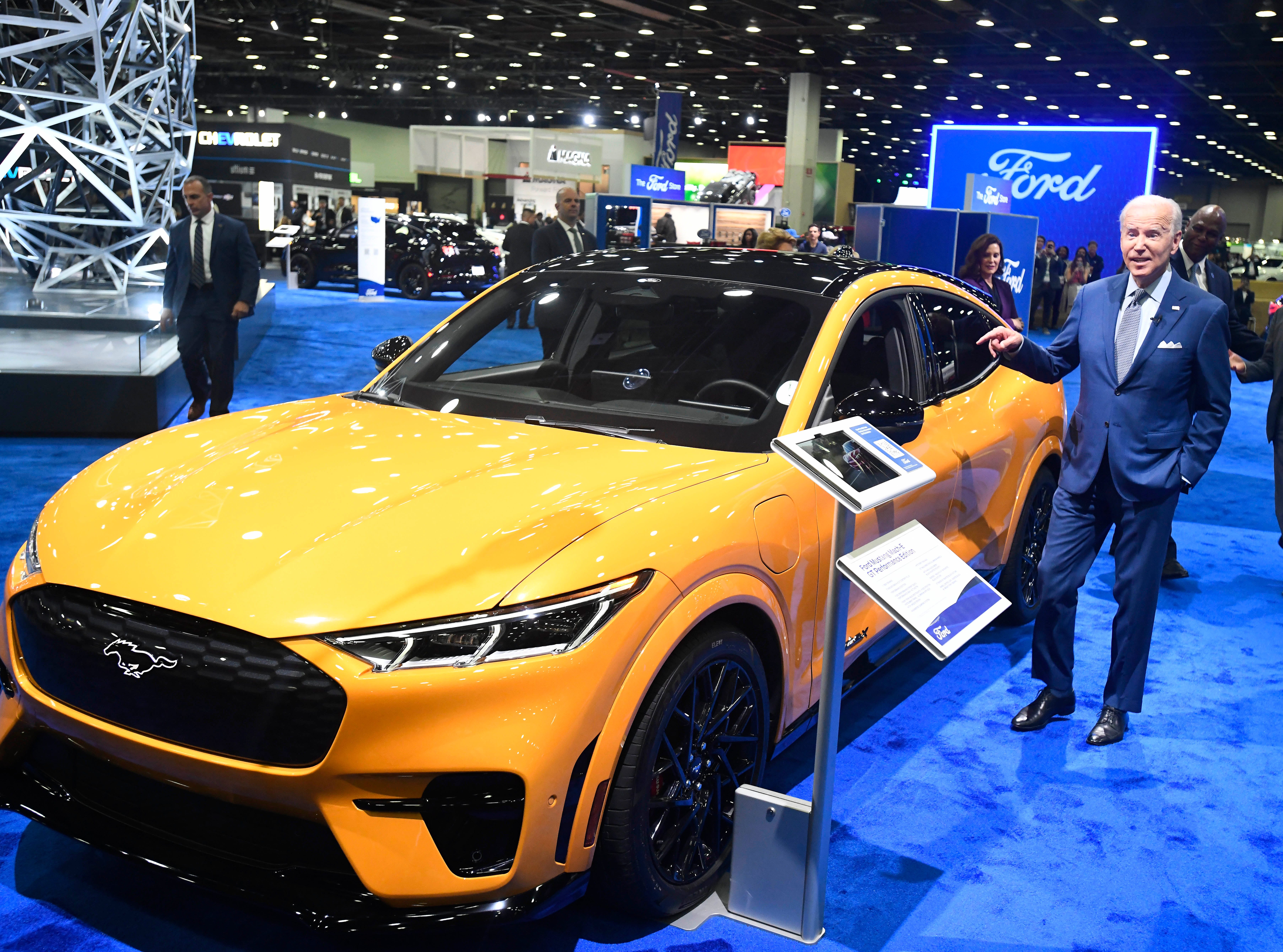 President Joe Biden looks over a Ford Mustang Mach-E during a tour of the 2022 North American International Auto Show in Detroit, Michigan on September 14, 2022.