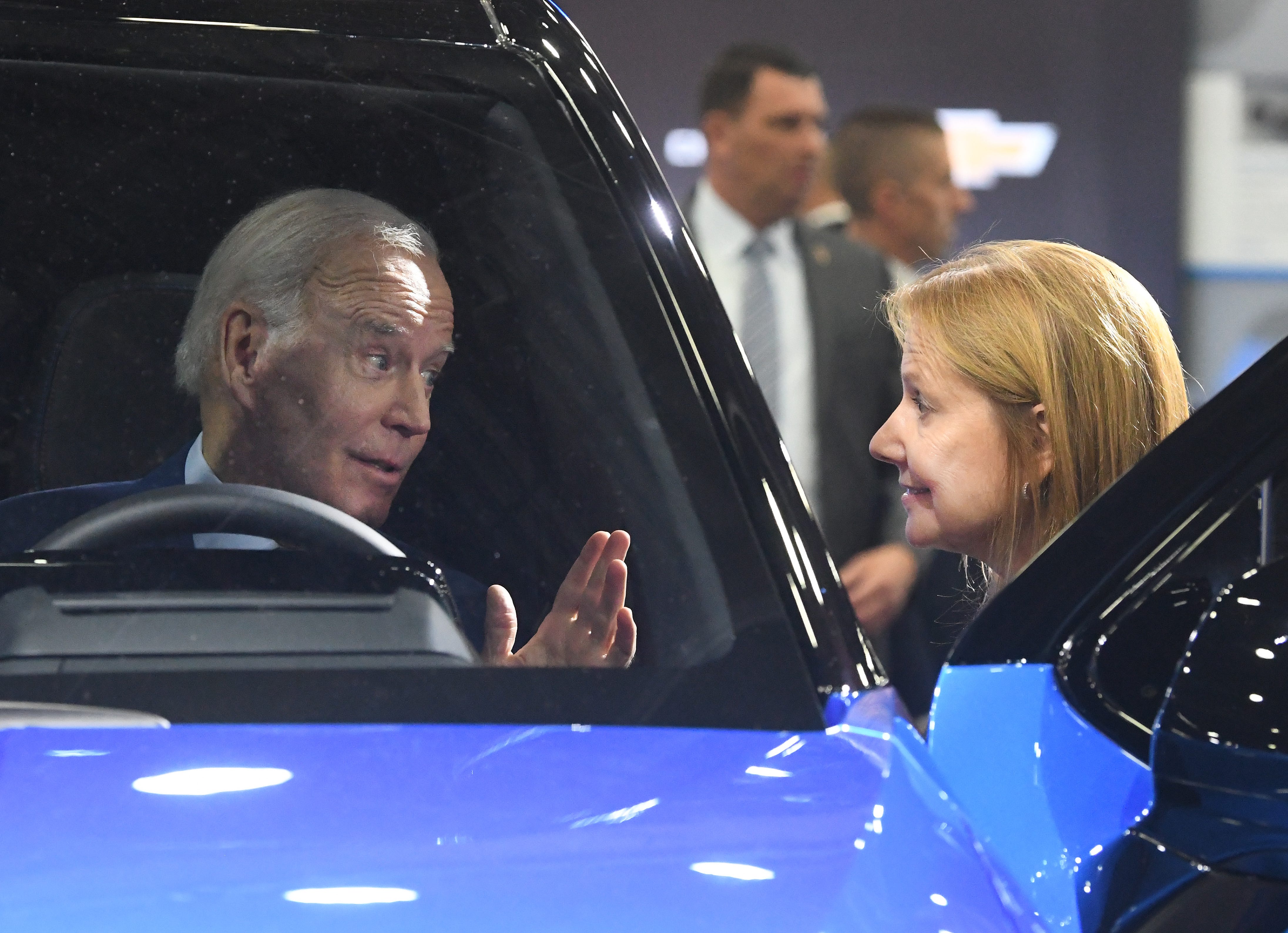 President Joe Biden sits in a Silverado EV, talking with General Motors chair and chief executive officer Mary Barra at the GM display during a tour of the 2022 North American International Auto Show in Detroit, Michigan on September 14, 2022.