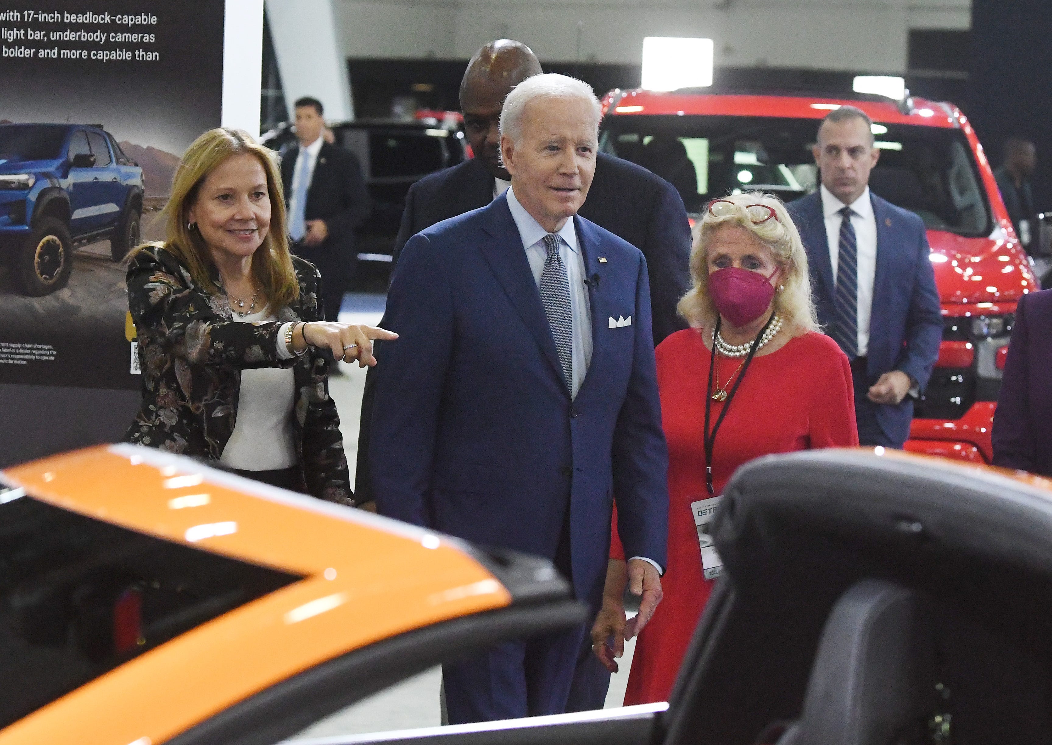 General Motors chair and chief executive officer Mary Barra shows President Joe Biden a blazing orange Corvette, with U.S. Representative Debbie Dingell, at the GM display during a tour of the 2022 North American International Auto Show in Detroit, Michigan on September 14, 2022.