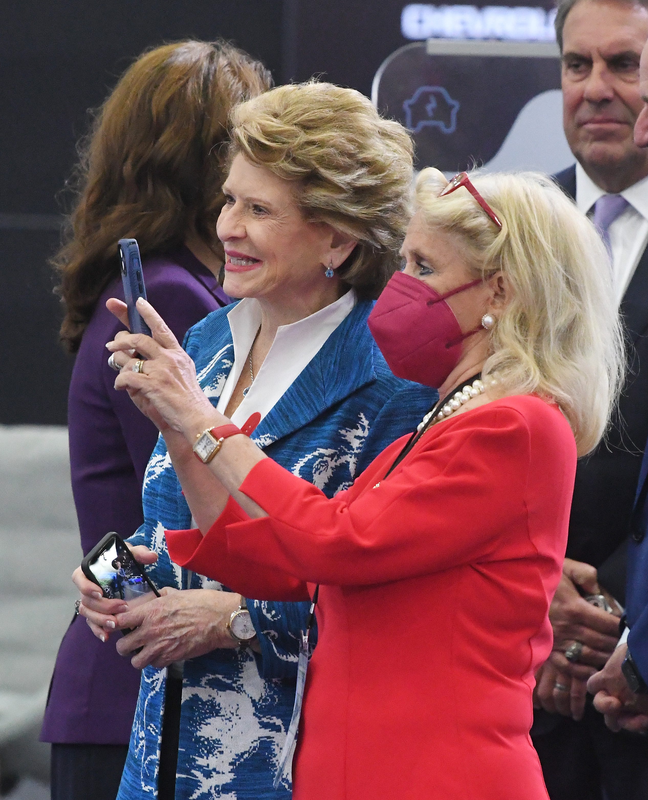 Senator Debbie Stabenow  and U.S. Representative Debbie Dingell take photos during a tour with President Joe Biden at the 2022 North American International Auto Show in Detroit, Michigan on September 14, 2022.