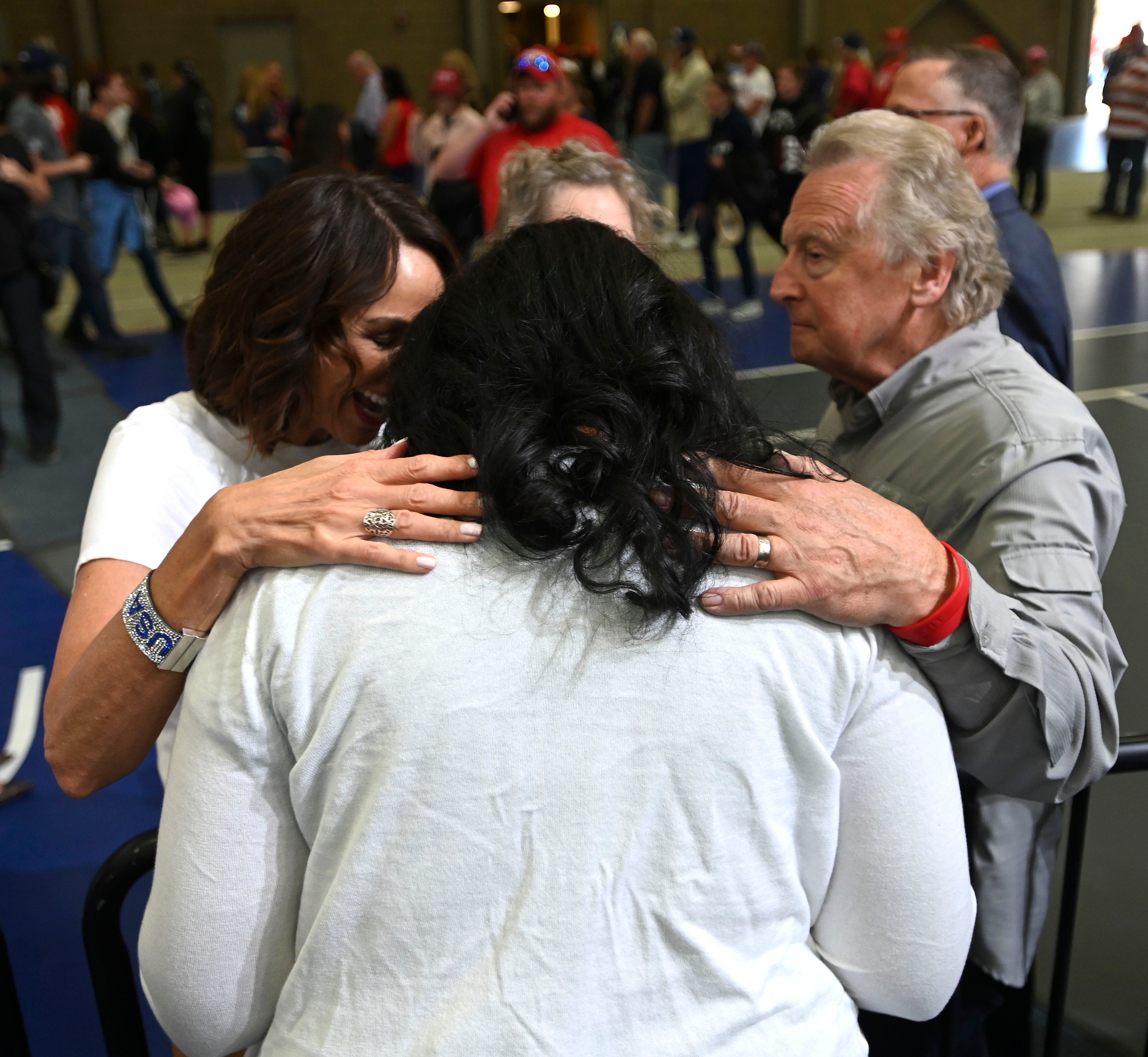 Lana Kristal, left, of Bingham Farms, volunteer prayer coordinator for the Kristina Karamo campaign and Rick Warzywak, right, director of Transformation Michigan and the Michigan Capitol House of Prayer, pray for Kristina Karamo, center, candidate for secretary of state, at a Donald Trump rally in Warren, Saturday, October 1, 2022.
