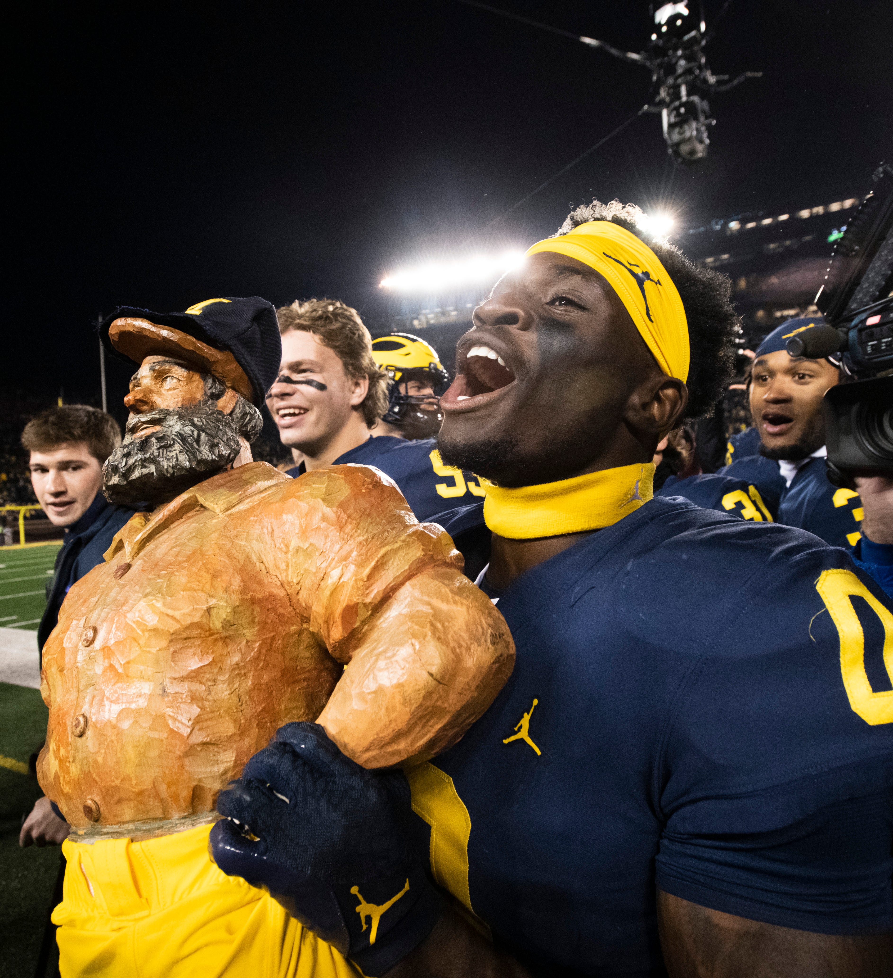 Michigan defensive back Mike Sainristil (0) carries the Paul Bunyan Trophy off the field after Michigan’s 29-7 victory over Michigan State in Ann Arbor. Michigan defeated Michigan State 29-7 in a college football game at Michigan Stadium in Ann Arbor, Michigan, Oct. 29, 2022.