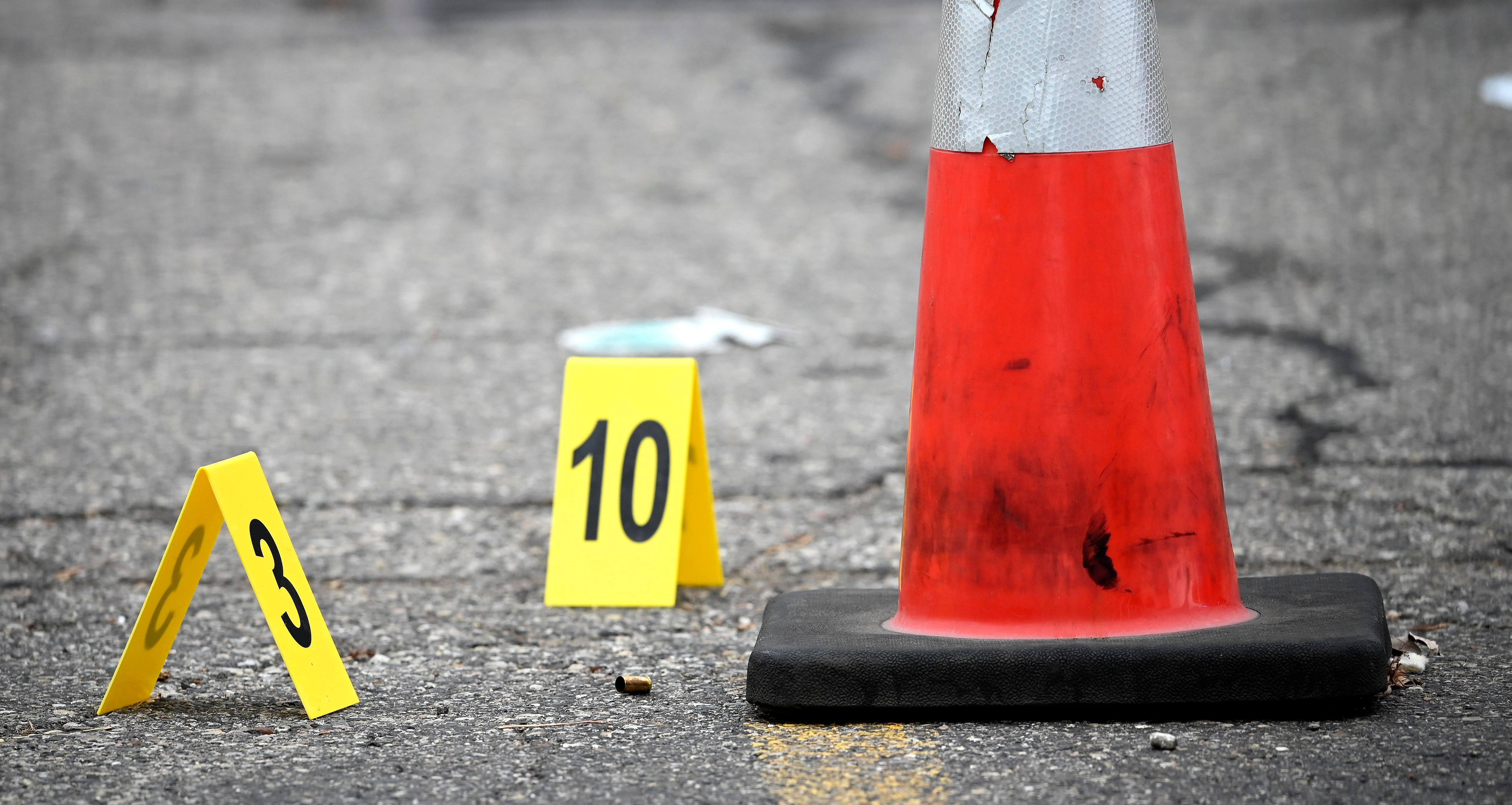 A shell casing and evidence markers in the front parking lot of the Faurecia plant in Highland Park, Wednesday afternoon, December 14, 2022.