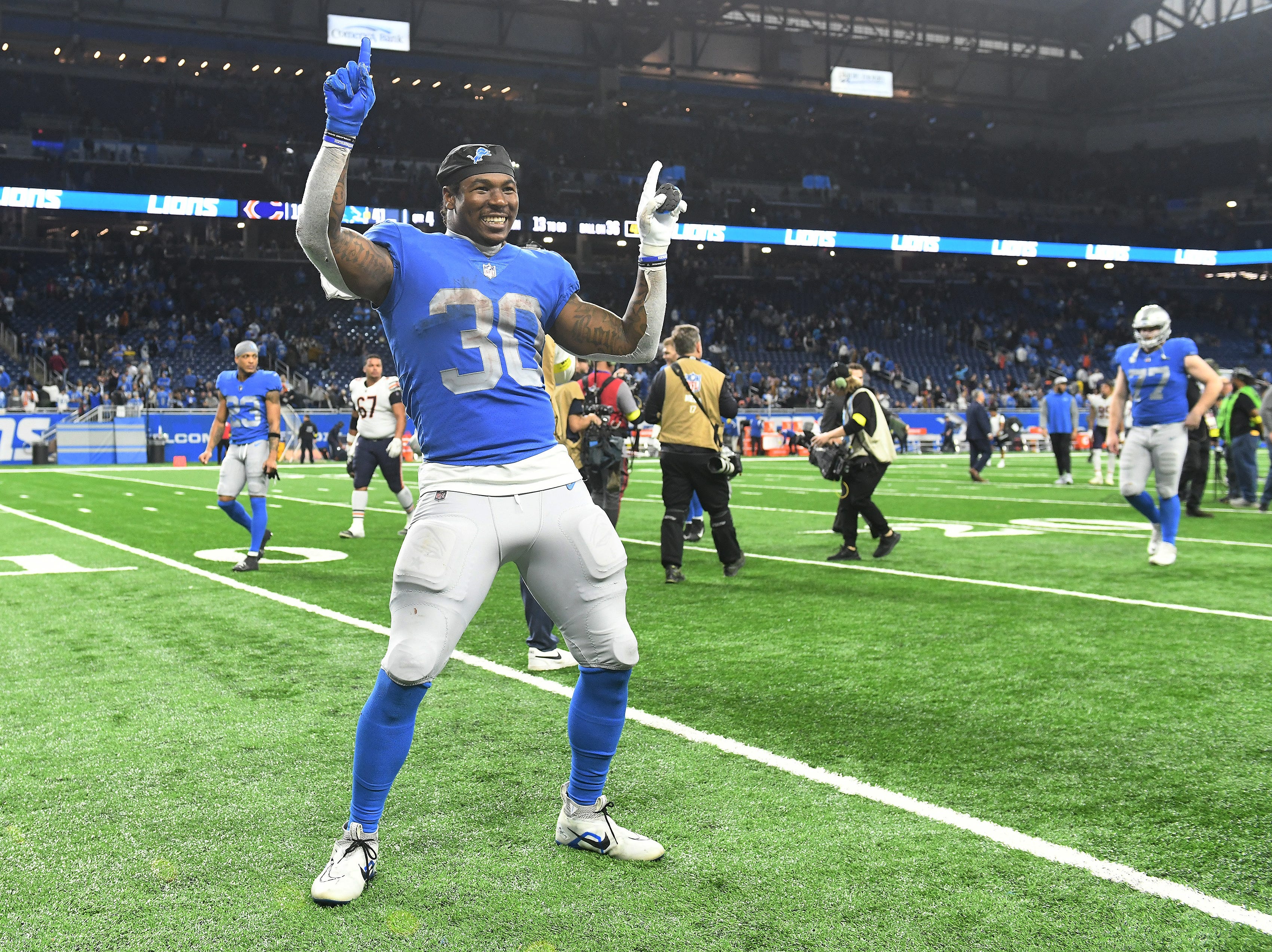 Lions running back Jamaal Williams (30) reacts with the crowd after the win.