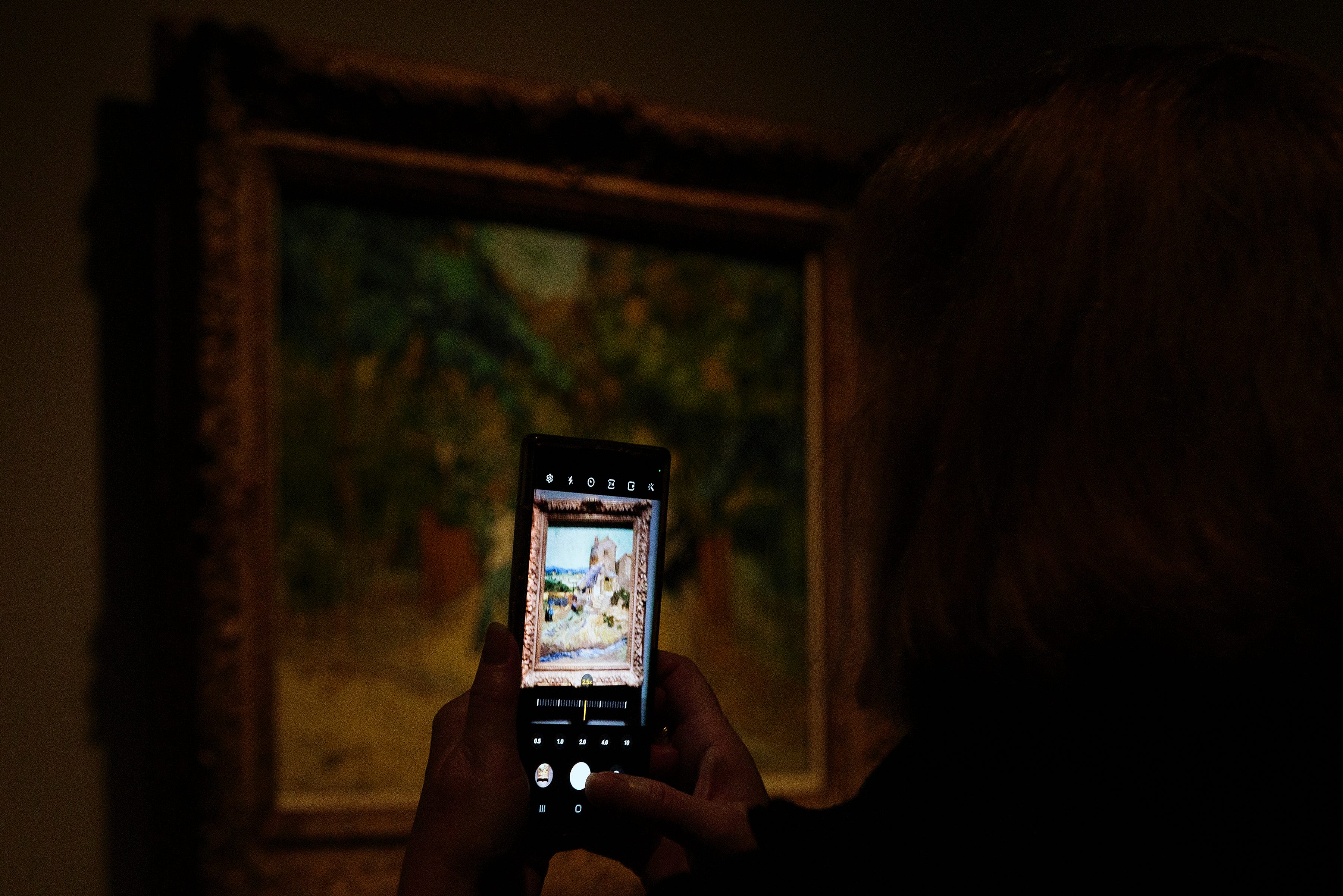 A visitor photographs a painting at the Van Gogh in America exhibit at the Detroit institute of Arts, Wednesday, Jan. 11, 2023.