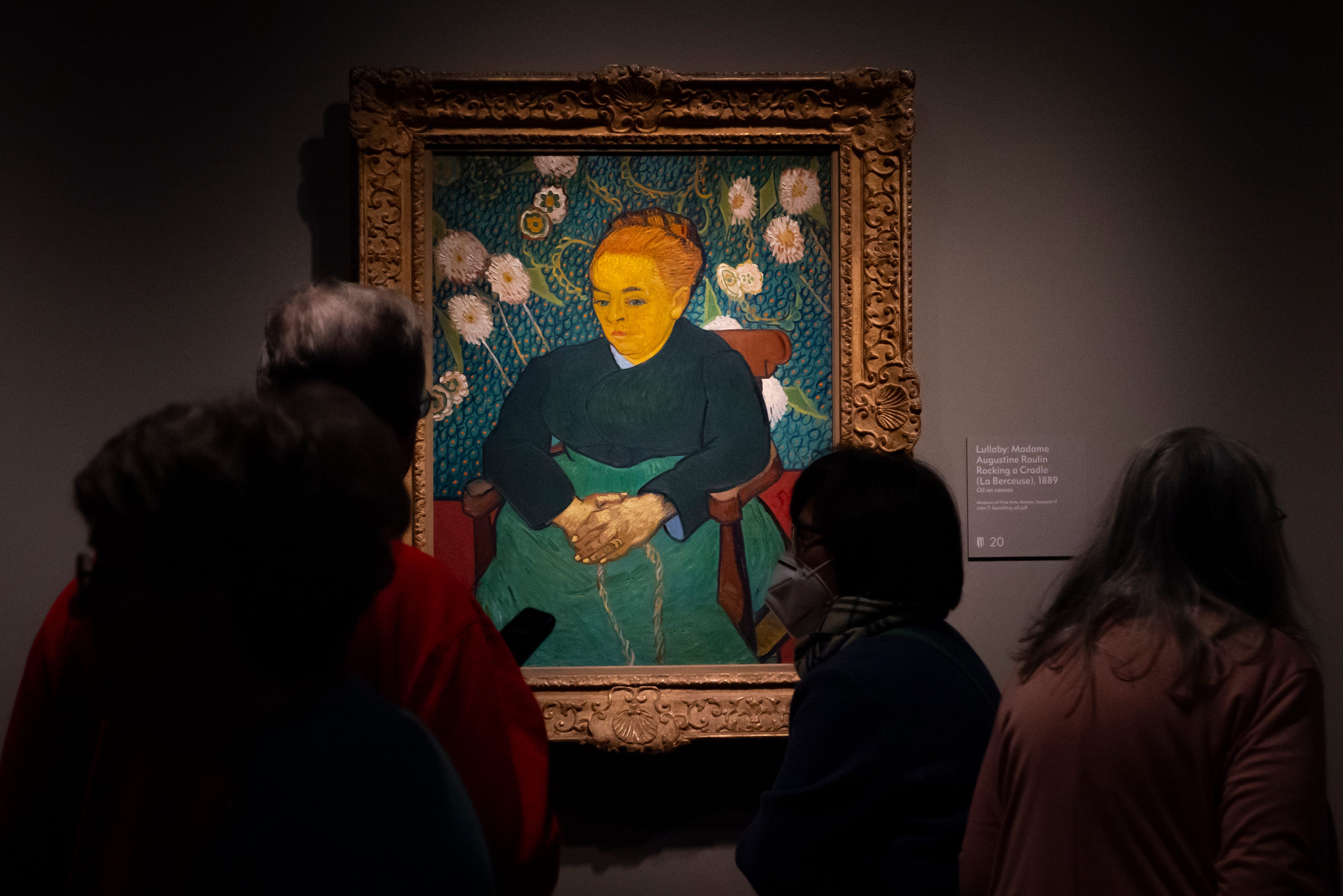 Visitors view Lullaby: Madame Augustine Roulin Rocking a Cradle (La Berceuse), 1889, at the Van Gogh in America exhibit at the Detroit institute of Arts, Wednesday, Jan. 11, 2023.