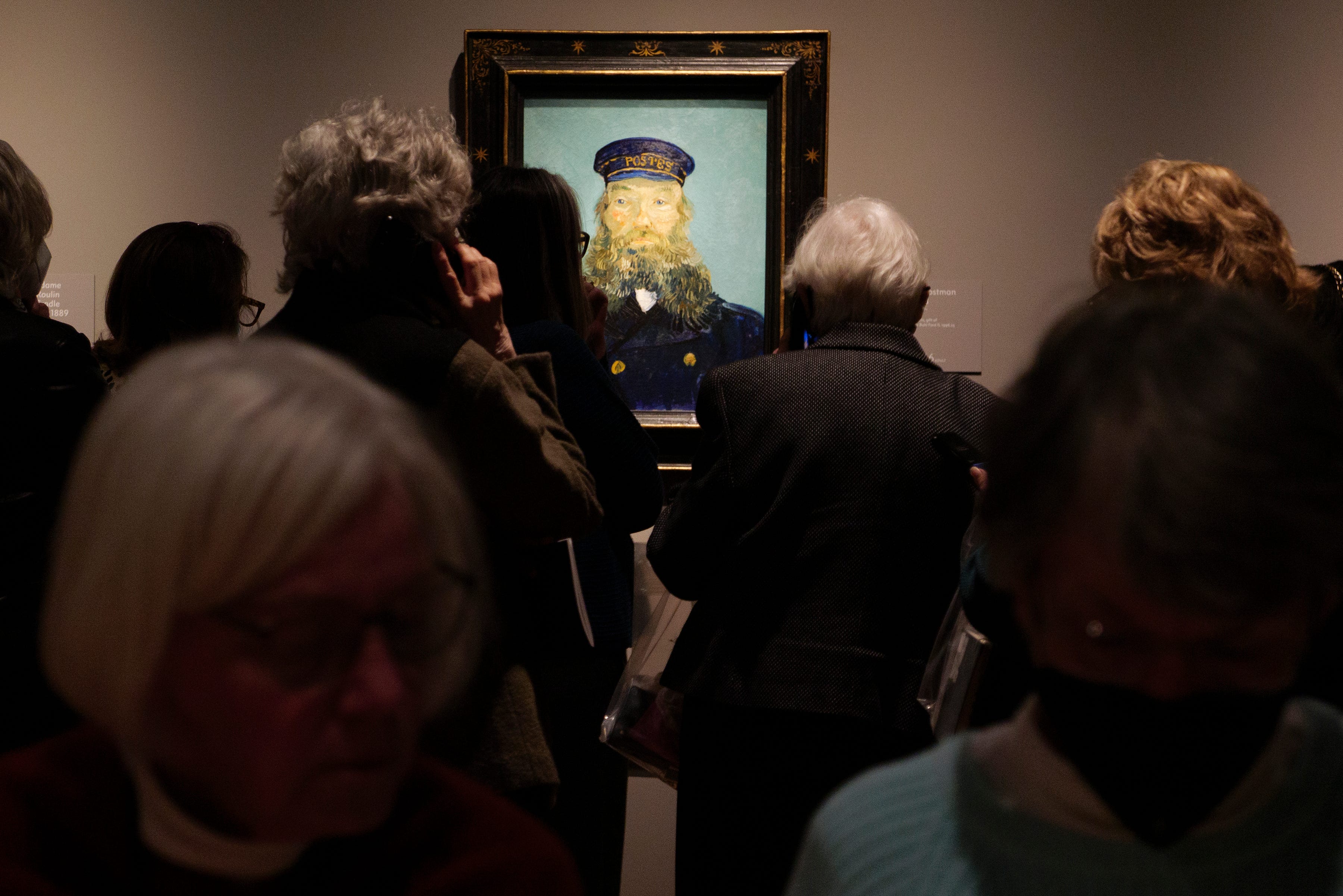 Visitors crowd around Portrait of Postman Roulin, 1888, at the Van Gogh in America exhibit at the Detroit institute of Arts, Wednesday, Jan. 11, 2023.