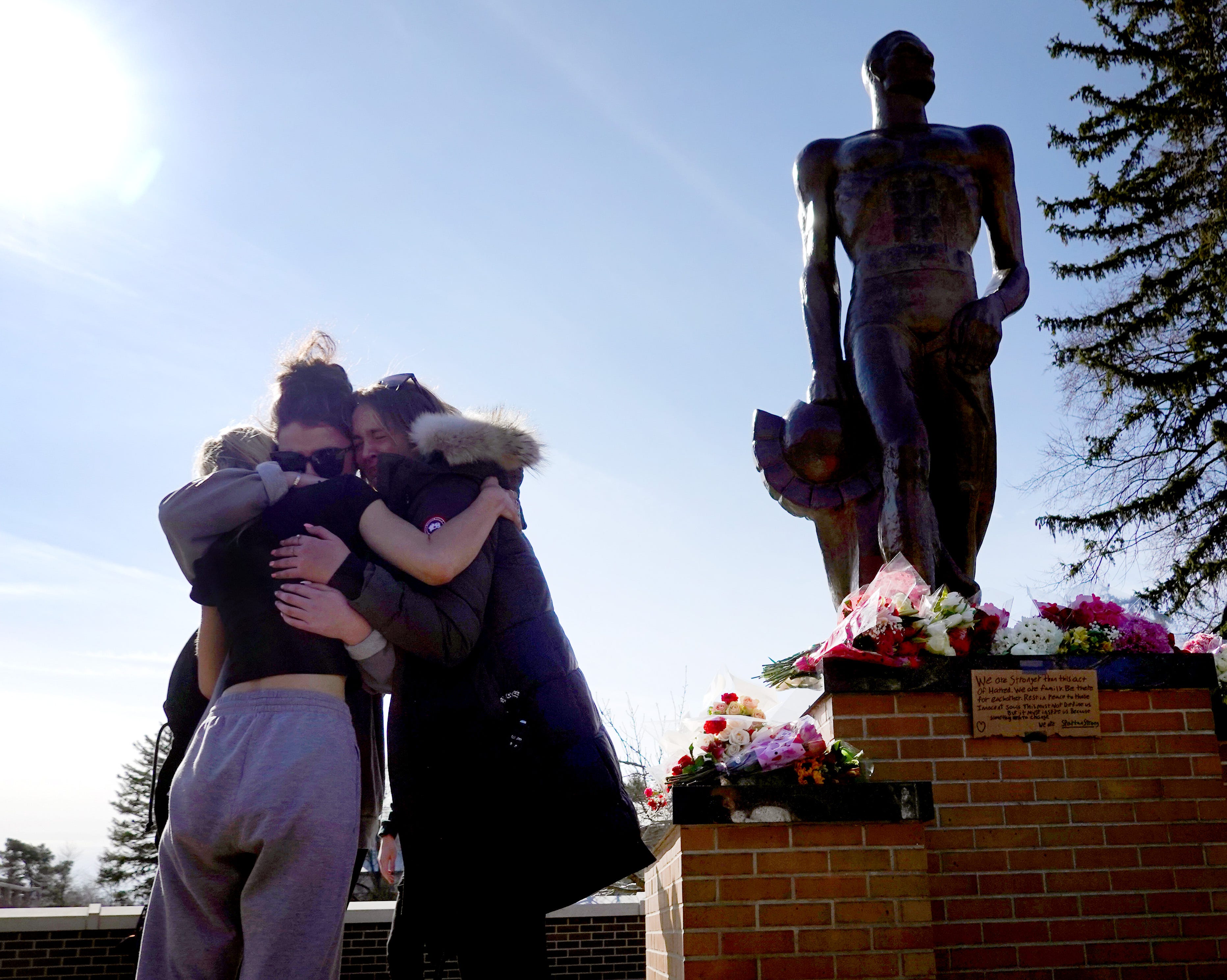 Students mourn and pray at the Spartan statue on the campus Michigan State University on February 14, 2023 in East Lansing, Michigan. A gunman opened fire at two locations on the campus last night killing three students and injuring several others.