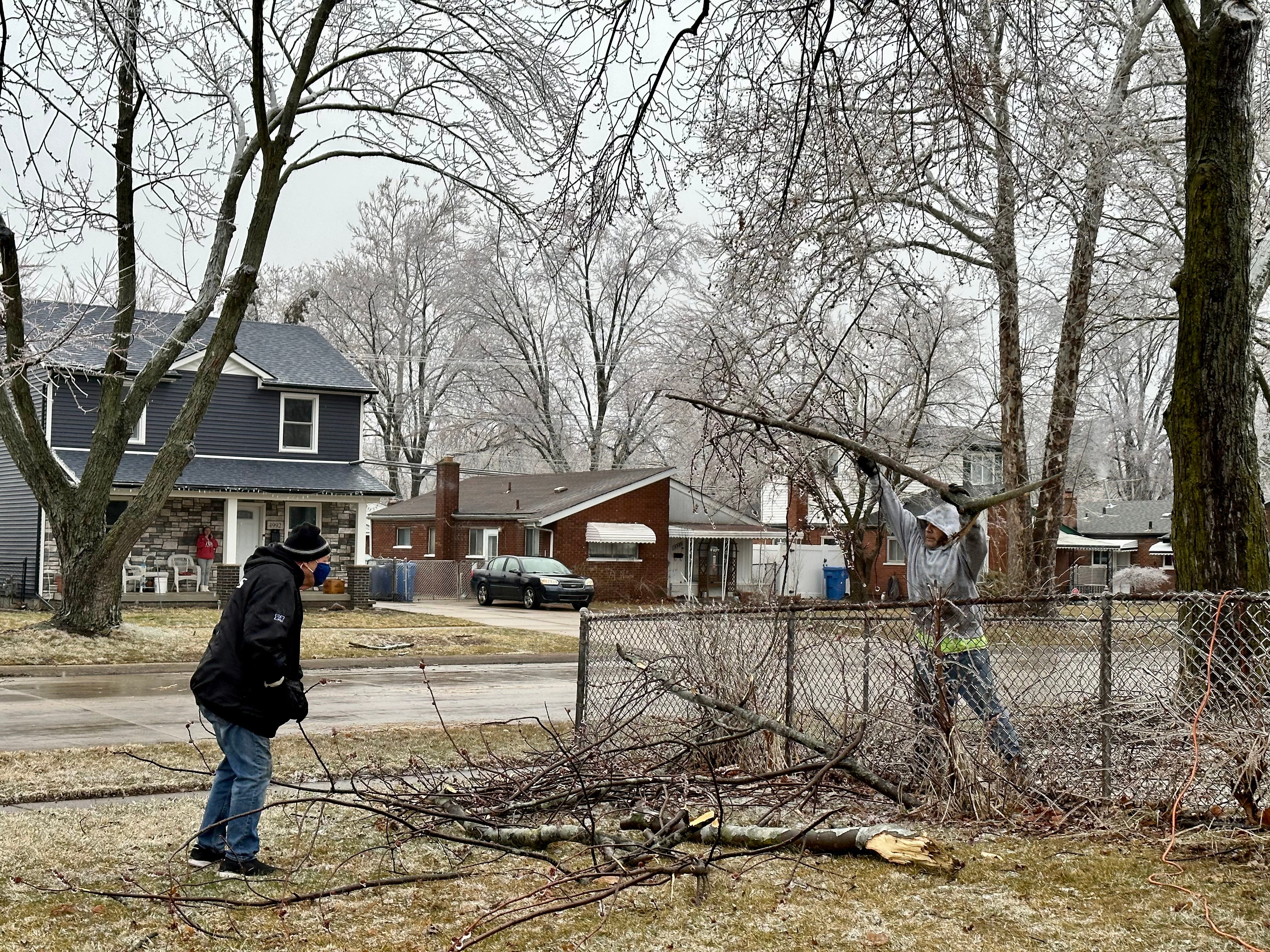 Rich Dennis, 80, left, and an unidentified neighbor who pitched in clean up Dennis' yard after several ice-covered branches crashed down in Dearborn. Rich's wife Barbara Dennis said they attempted to clean up the yard themselves, but the branches were too large, heavy and some not yet fully detached from the tree. Soon enough, their new neighbor assisted with ladders and saws. The Good Samaritan wished to remain unnamed. 
"We didn't expect anyone to help, but this new neighbor kindly offered. We're not used to it because people just don't do that anymore," Barbara Dennis said.