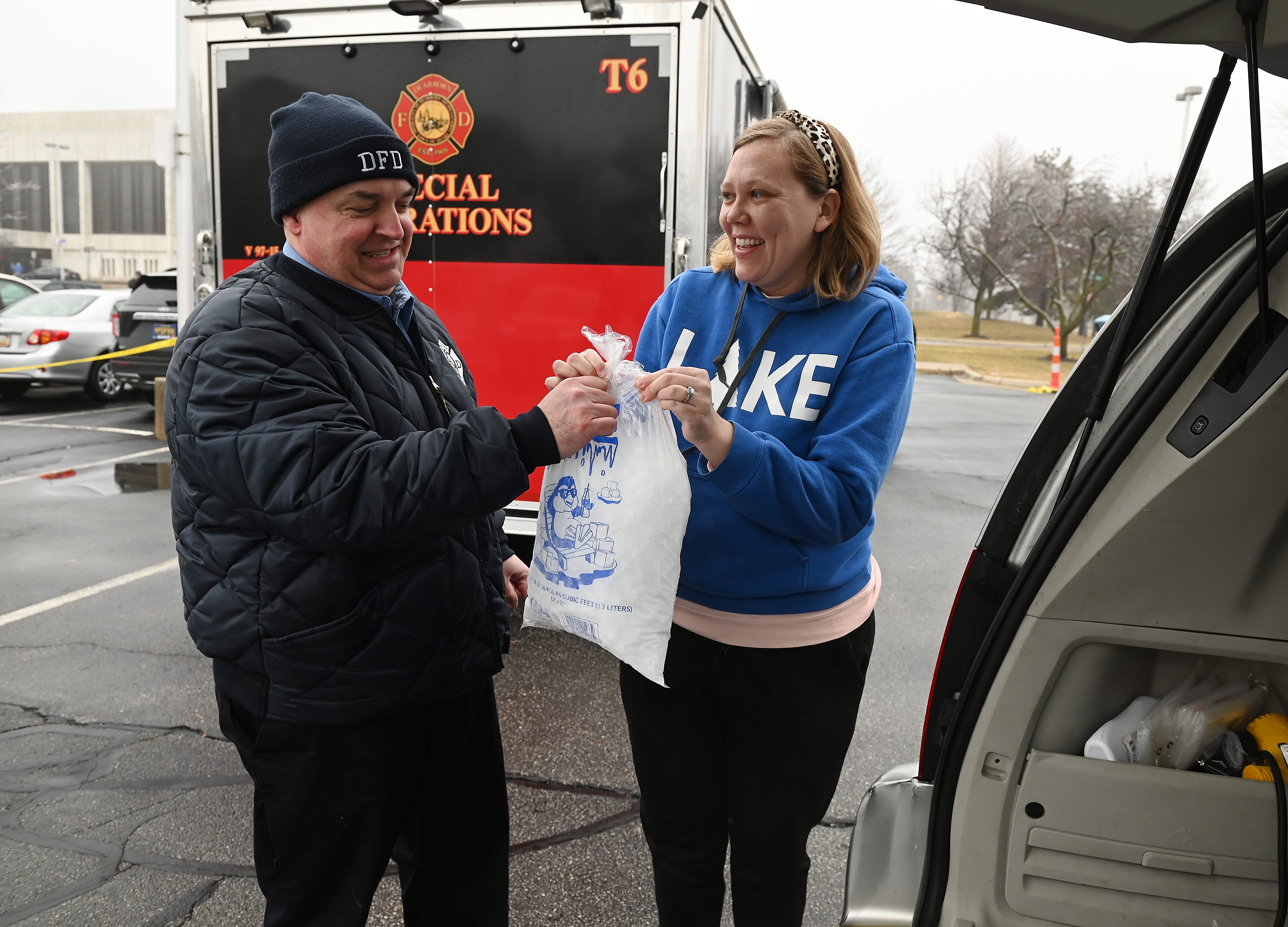Emily Brady, 35, of Dearborn, is happy to receive two bags of dry ice from Jim Rodgers, Emergency Manager Coordinator for the City of Dearborn, during the free give away by the City of Dearborn to help residents affected by the ice storm. February 23, 2023, Dearborn, MI.
