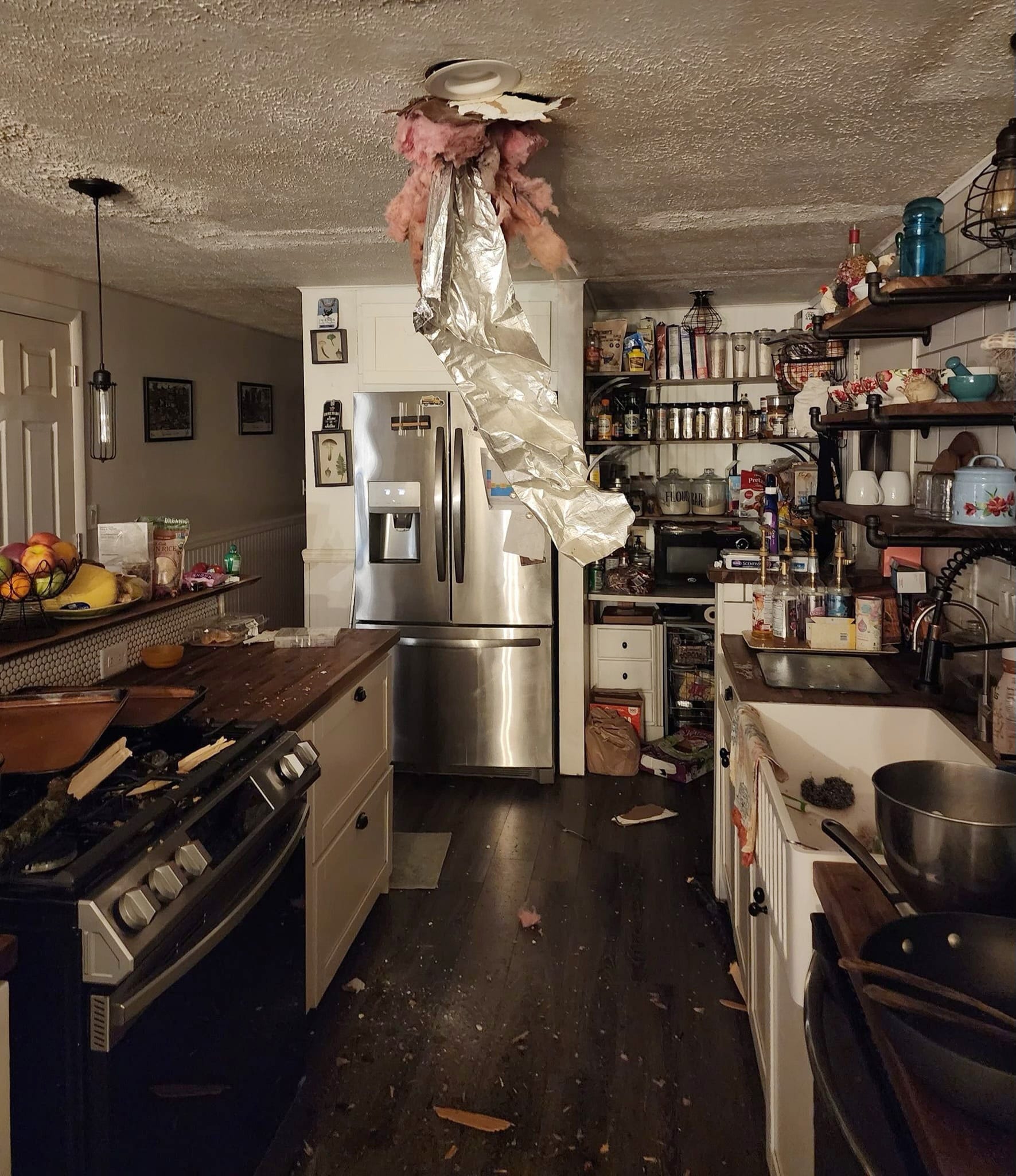 A tree limb downed by ice accumulation from Wednesday's storm tore through the ceiling in the kitchen of Nicole Streeter's home on Wells Road in Dundee.