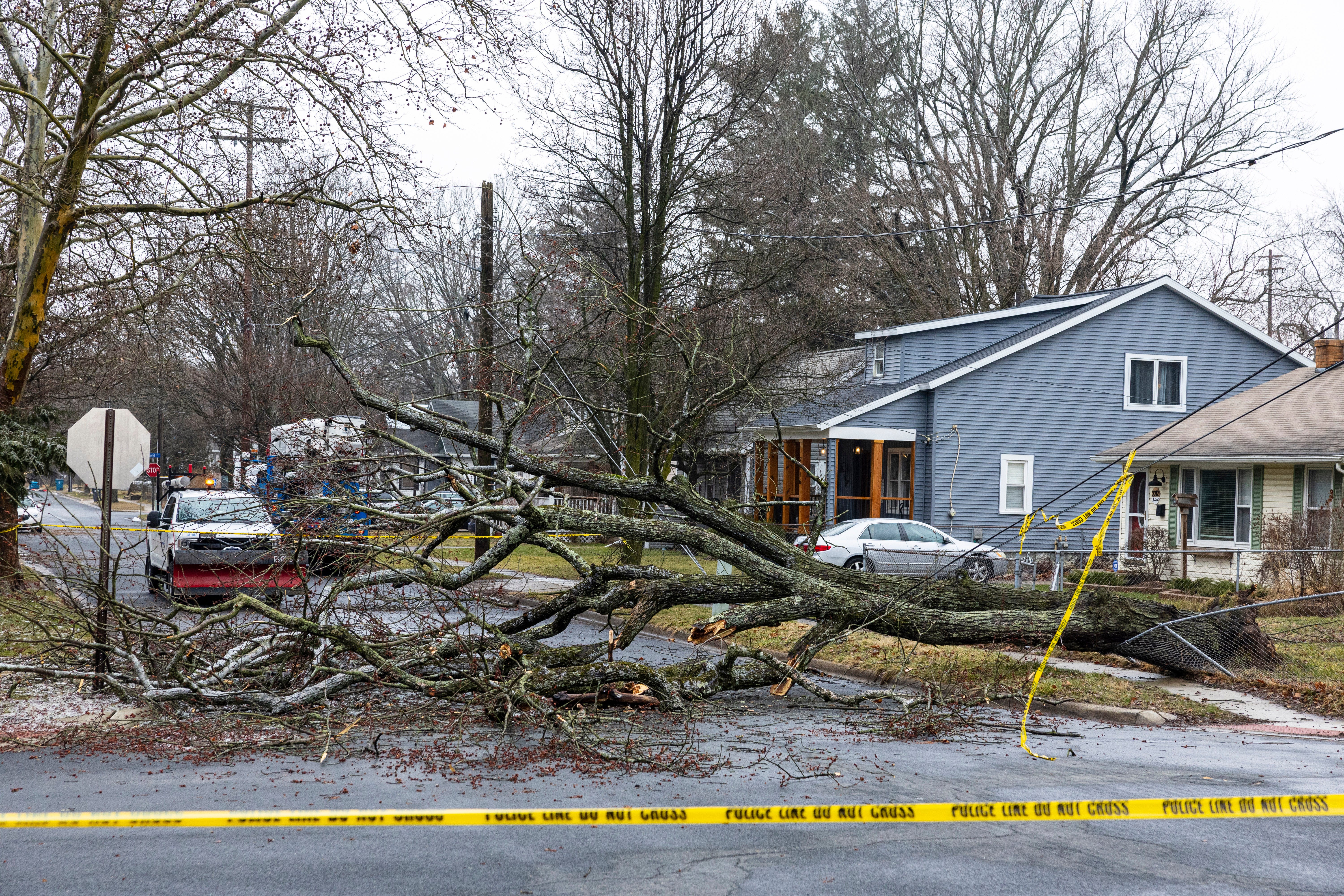 Downed trees block a road following an an ice storm in the Oakwood neighborhood in Kalamazoo.