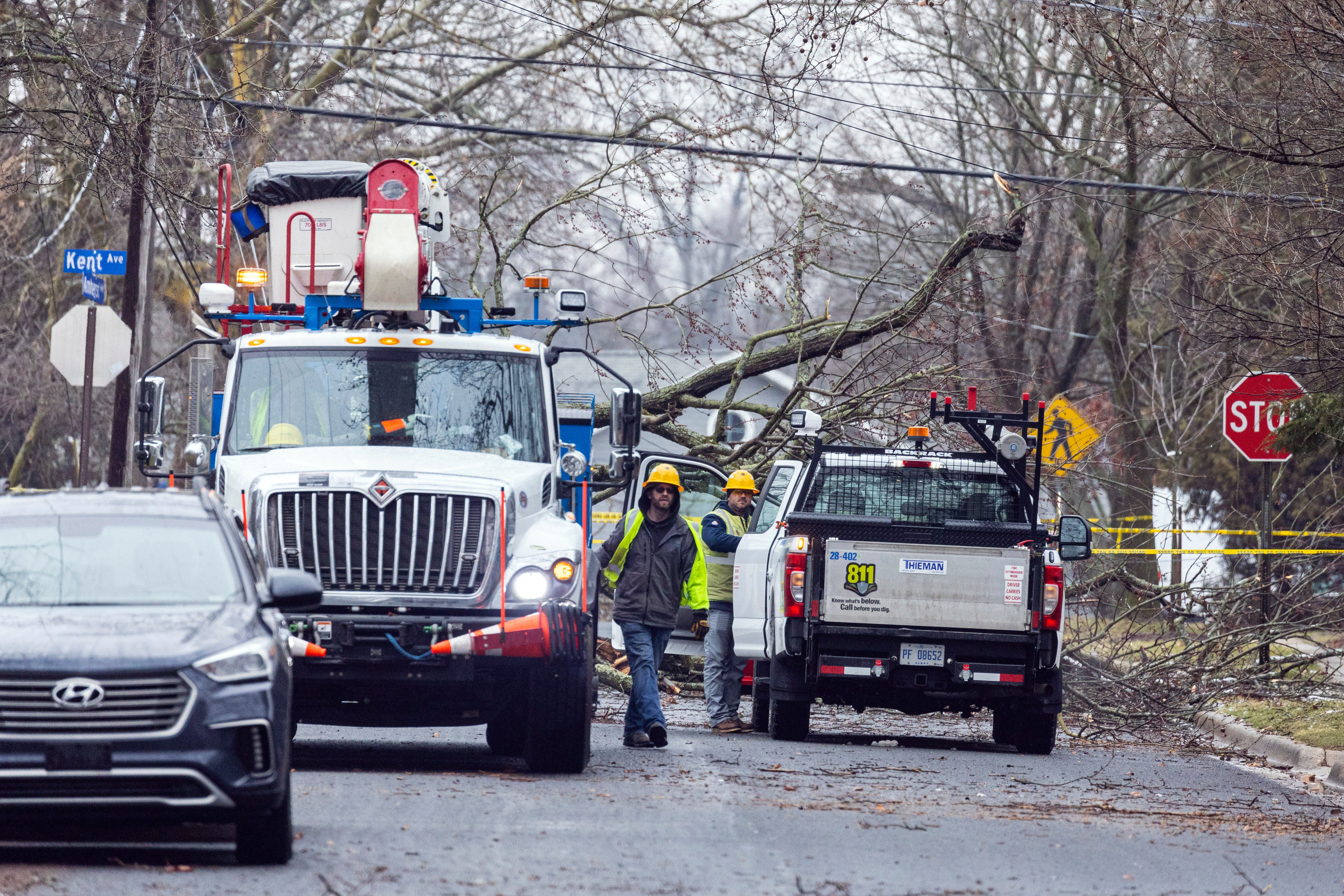 Consumers Energy works to repair lines and remove downed trees following an an ice storm in the Oakwood neighborhood in Kalamazoo.