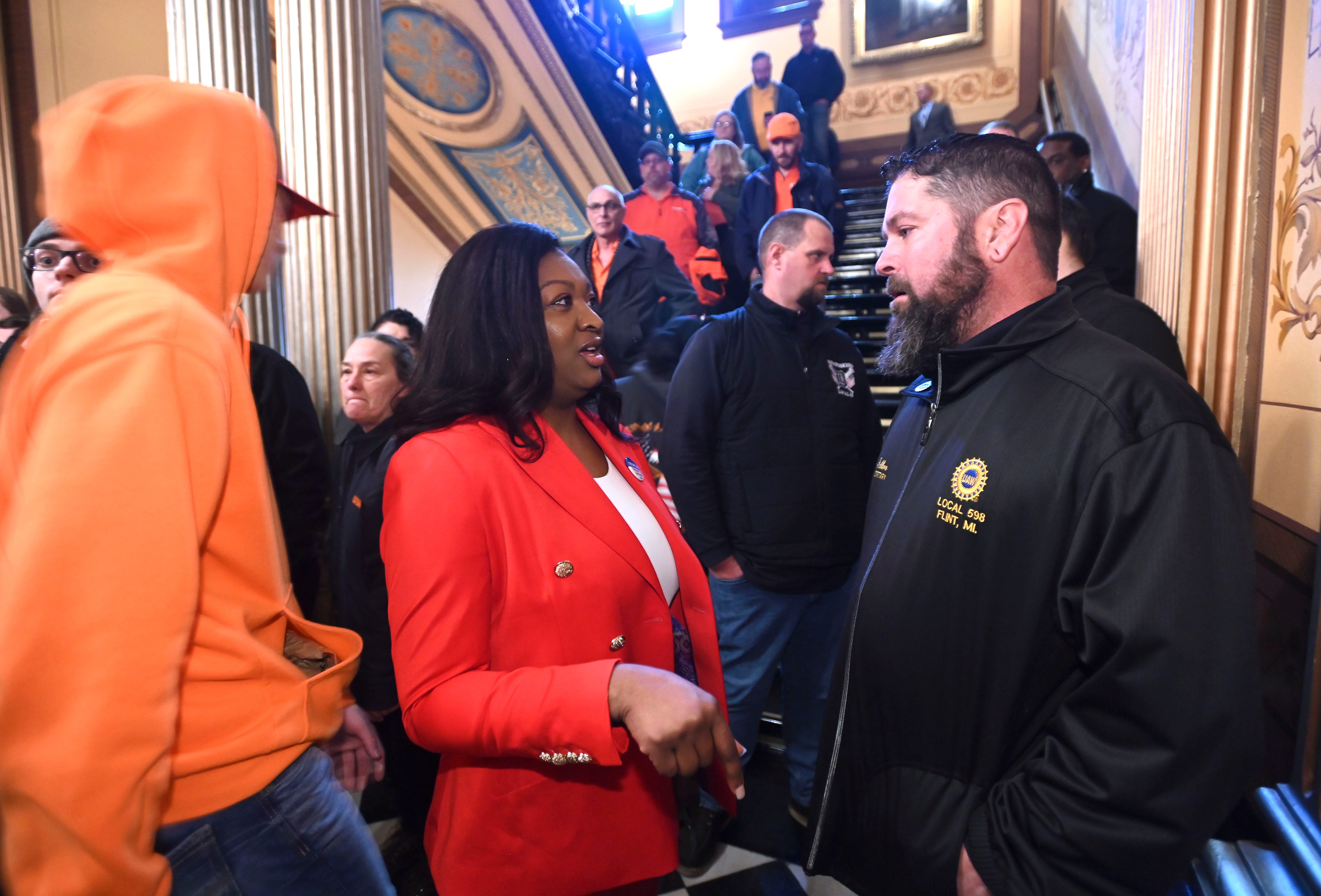 Senator Sarah Anthony, left, talks with Chad Fabbro, of Vassar, outside Senate chambers, Tuesday morning, March 14, 2023. Fabbro is the financial secretary of UAW Local 598 out of Flint.