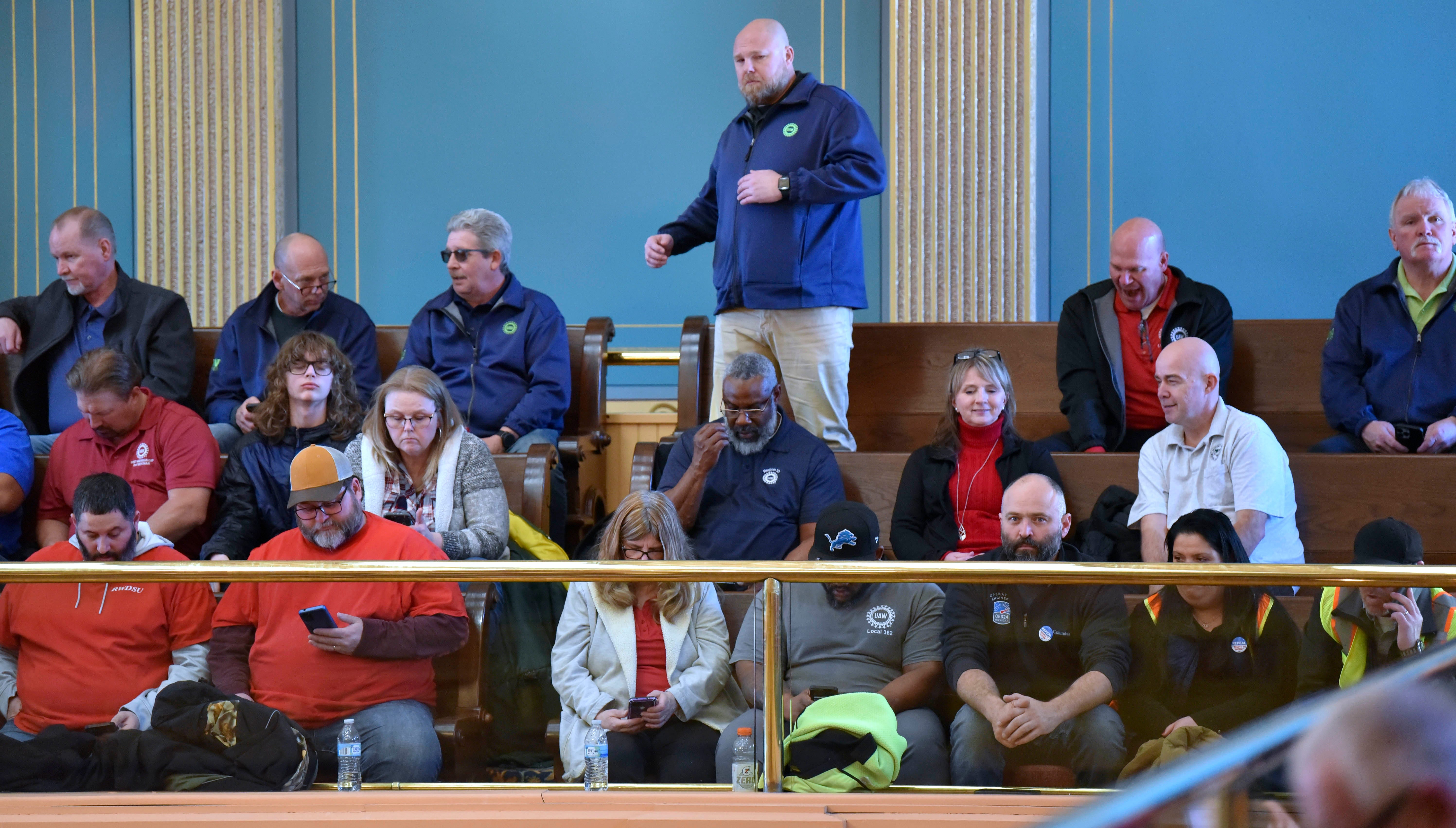 Ted Krumm, of Lansing, stretches while sitting in the gallery with other union members and supporters as they wait for the Senate to vote, Tuesday afternoon, March 14, 2023. Krumm is a UAW Region 1-D Servicing Rep. for the Lansing area.